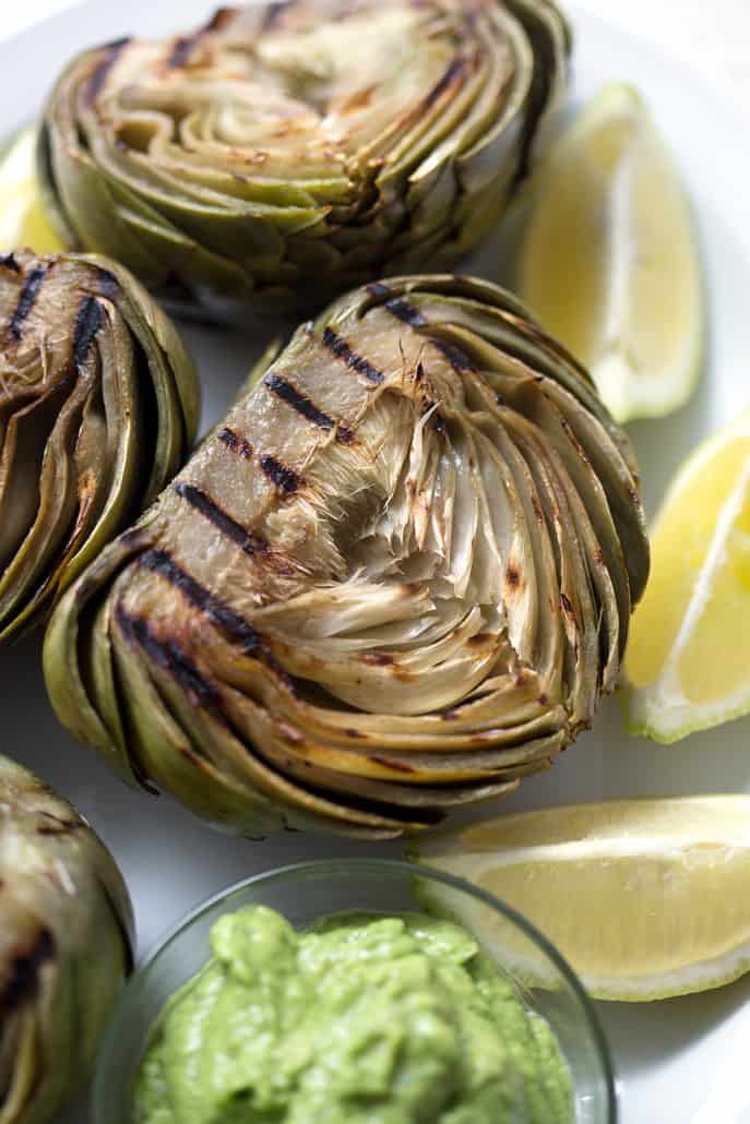 grilled artichokes with lemon wedges