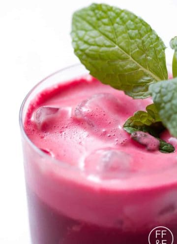 close up of beet juice garnished with mint sprig