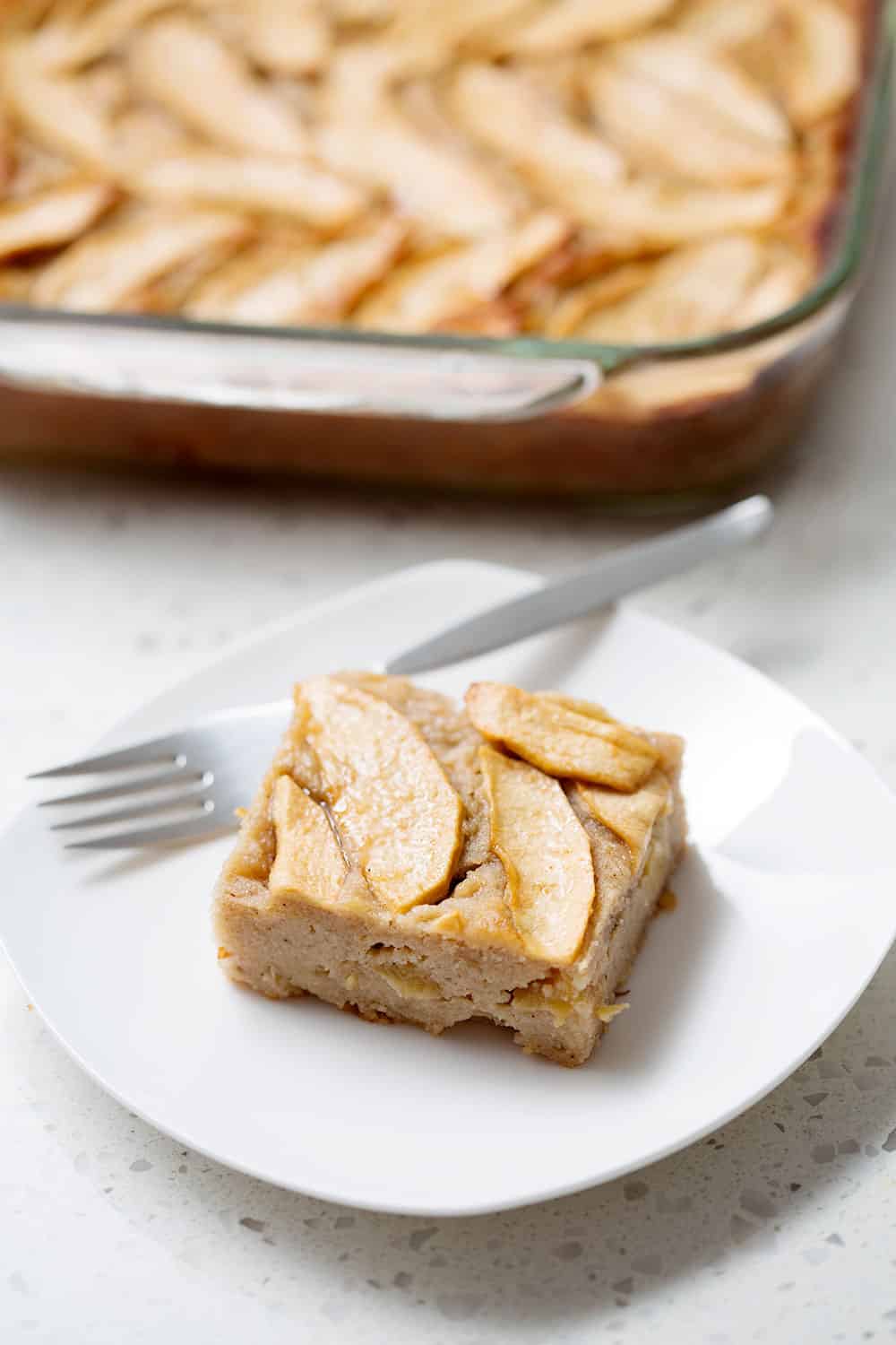 Piece of AIP Gooey Apple Sheet Cake on plate with fork