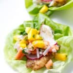 breaded fish in lettuce with fruit salsa