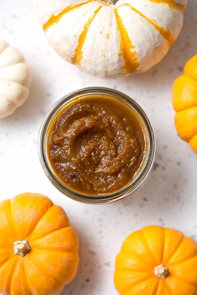 pumpkin butter in container with mini pumpkins