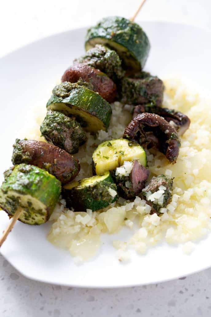 grilled meat skewer on plate with vegetables and cauliflower rice