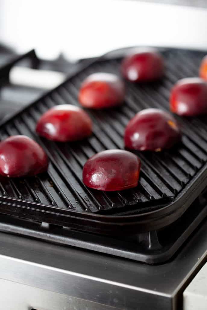 peach halves face down on grill pan