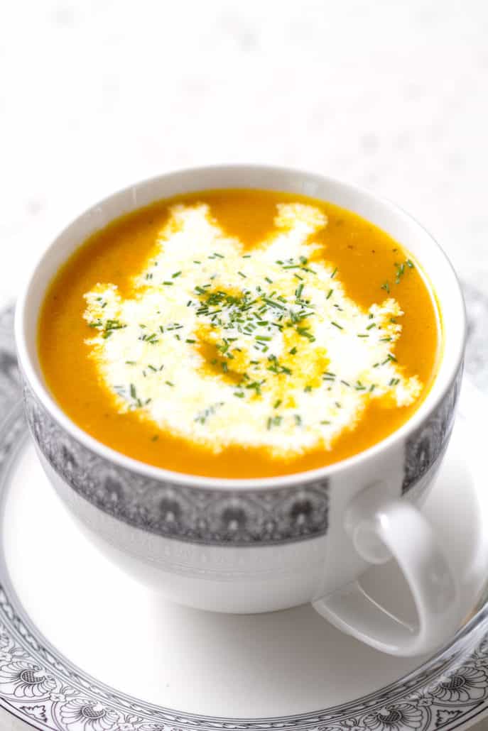 close up of carrot ginger soup in a cup