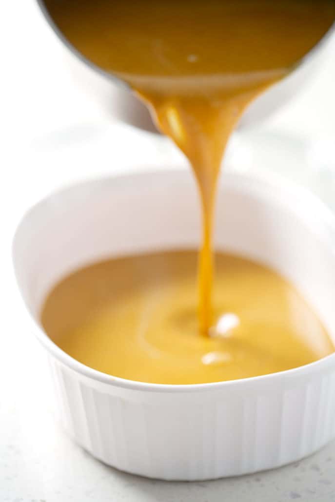 pouring aip pumpkin pudding into casserole