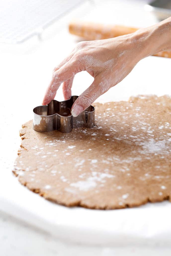 using cookie cutter to make gingerbread cookies