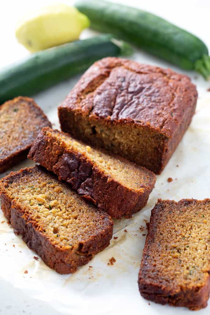slices of aip zucchini bread surrounded by a lemon and zucchini