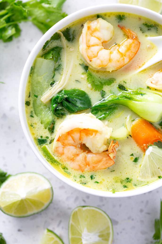 bowl of AIP Coconut Milk Curry Soup surrounded by lime wedges