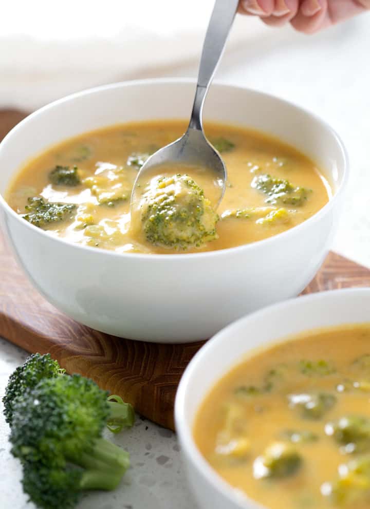 spooning up AIP Broccoli Cheese Soup out of bowl