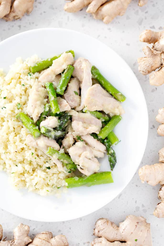 plate of AIP Ginger Chicken and Asparagus Stir Fry with cauliflower rice