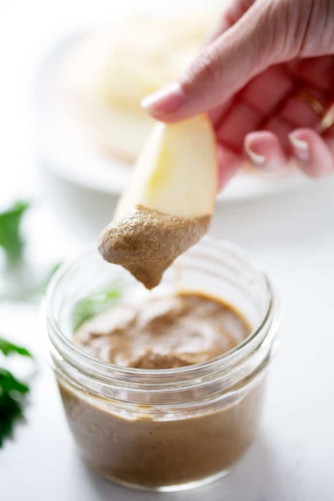 apple being dipped into mason jar of Beef Liver Pate