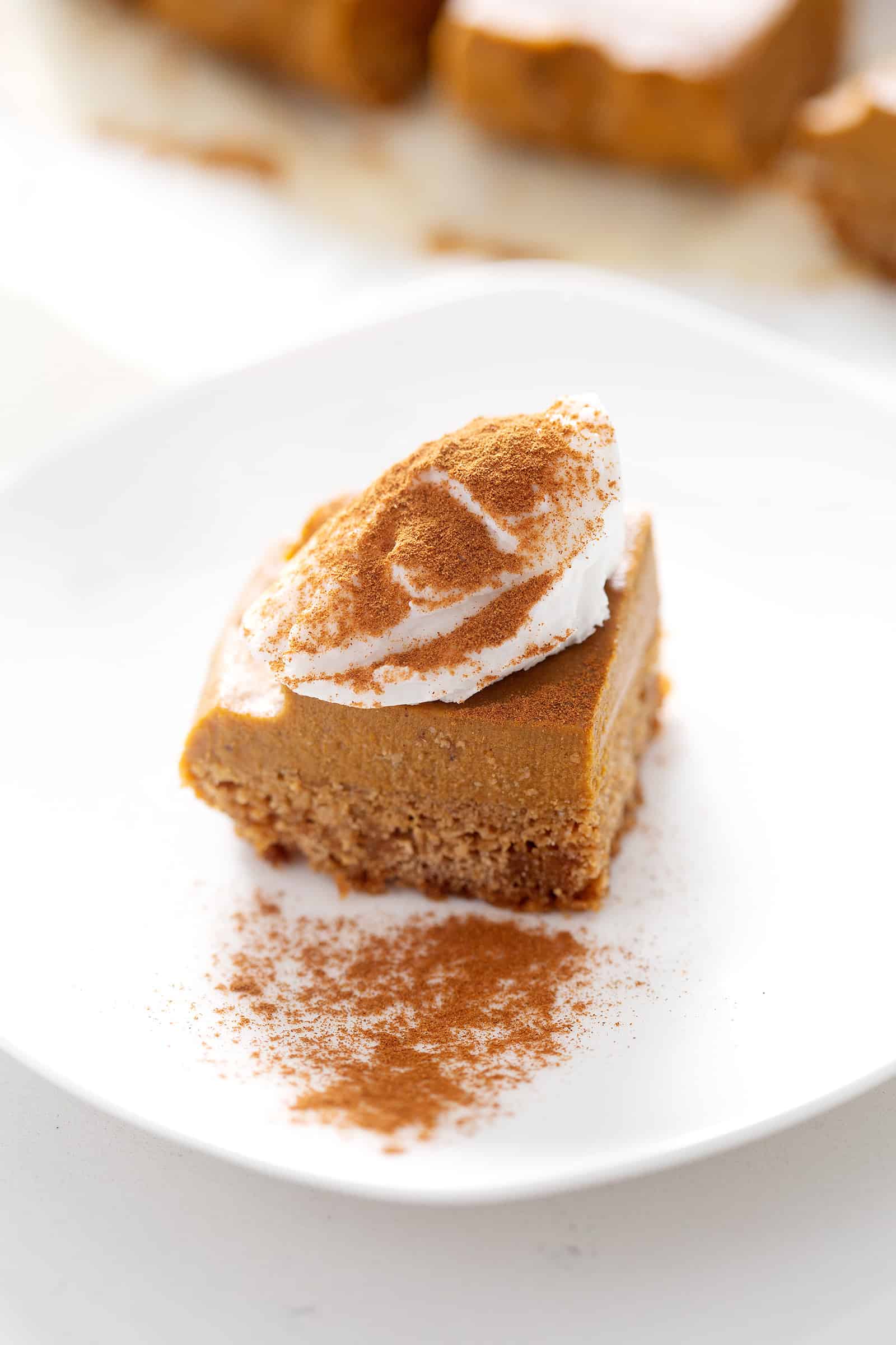 piece of AIP Pumpkin Pie Bars with topping on white plate